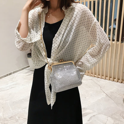 Woman wearing silver rhinestone evening bag with gold pearl chain strap crossbody style