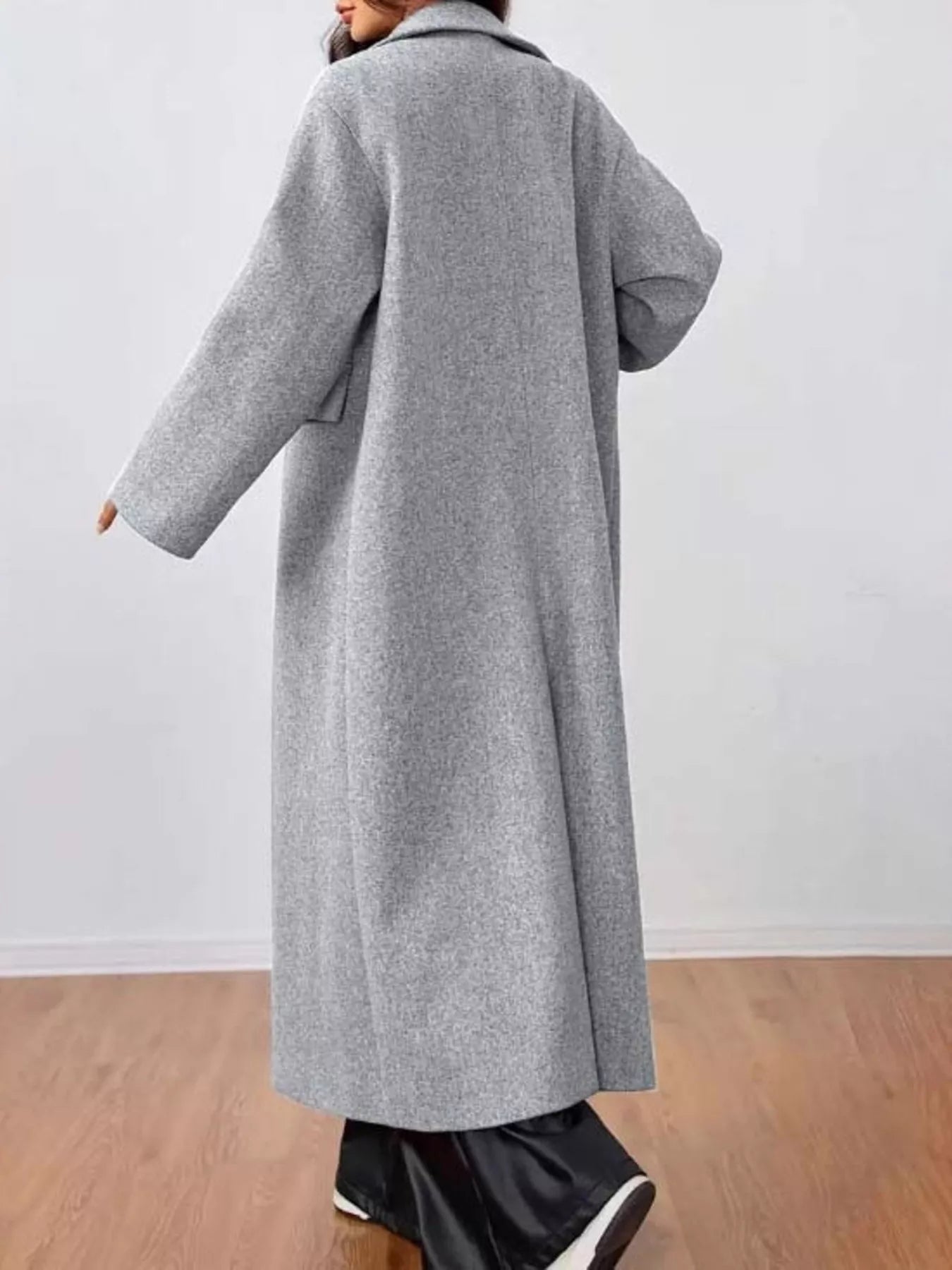 woman wearing a longline gray coat back view