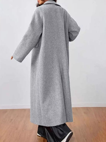 woman wearing a longline gray coat back view