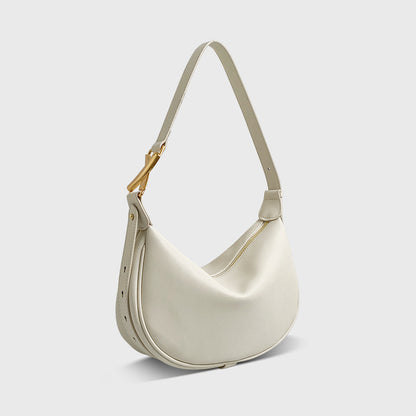 A white crescent-shaped genuine leather handbag with an adjustable strap and a zipper top closure.