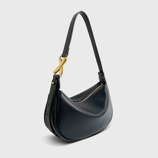 A black crescent-shaped genuine leather handbag with an adjustable strap and a zipper top closure.