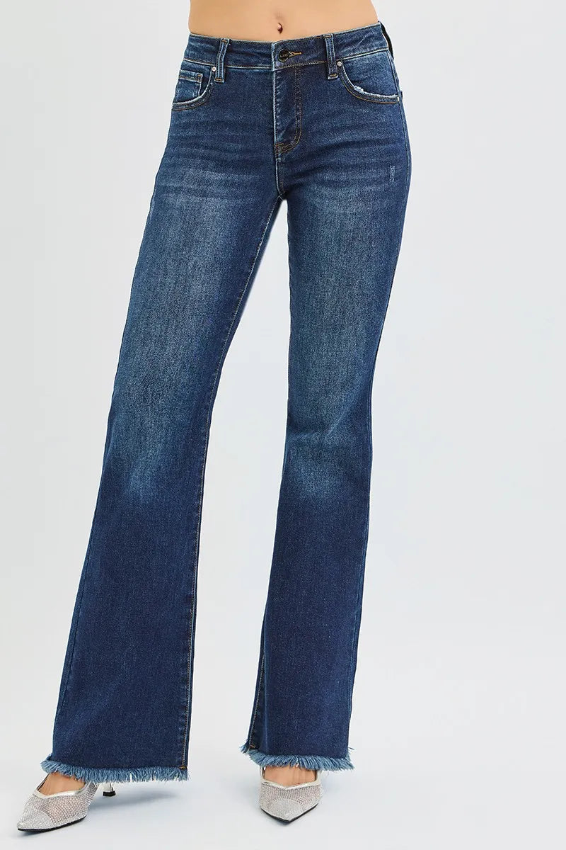 woman wearing dark wash blue denim mid rise flare leg tummy control jeans 