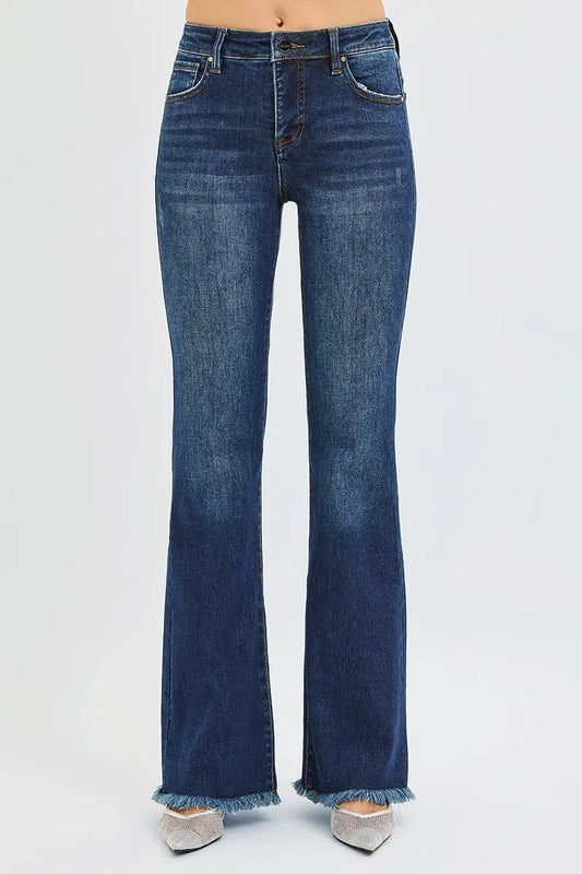 Front view of woman wearing dark wash blue denim mid rise flare leg tummy control jeans 