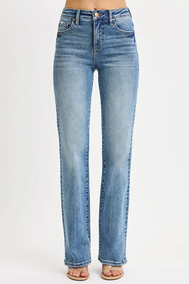 woman wearing stretchy medium wash  light blue high rise tummy control straight leg jeans on a white background
