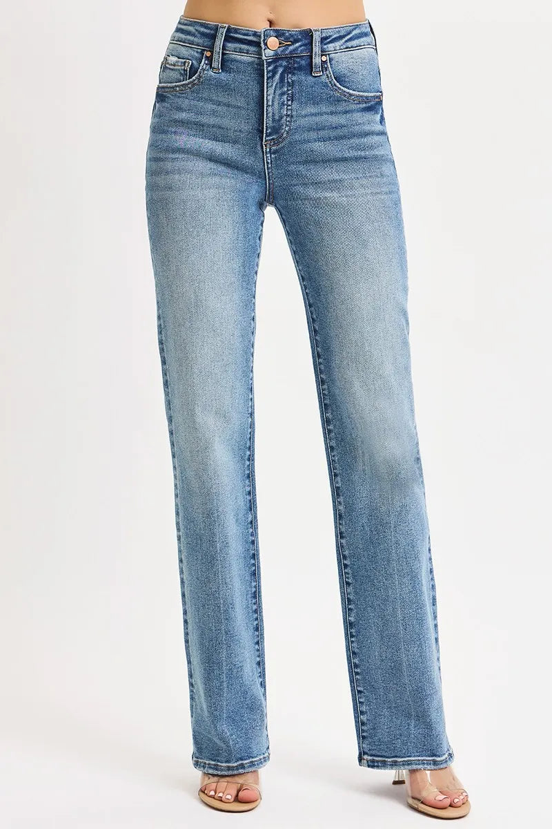 woman wearing slightly stretchy medium wash blue high rise tummy control straight leg jeans on a white background