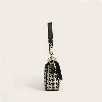Classic houndstooth pattern purse with gold hardware and pearl-like bead accents