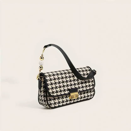 Women's houndstooth handbag with gold-tone lock and fashion-forward design